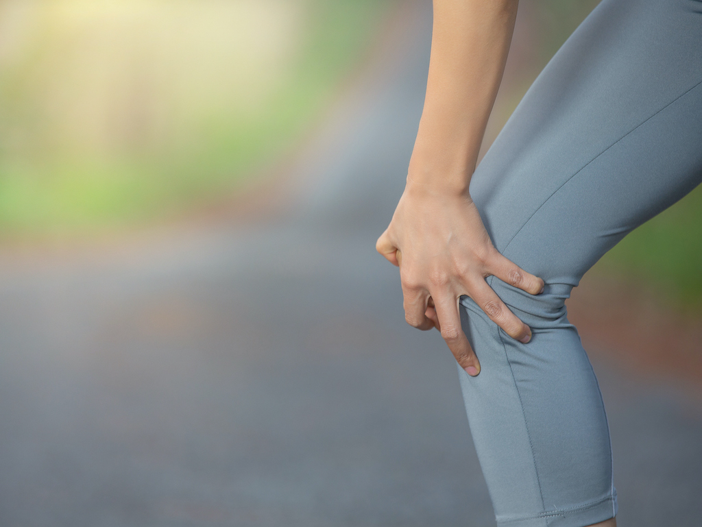 woman runner hold Knee Pain