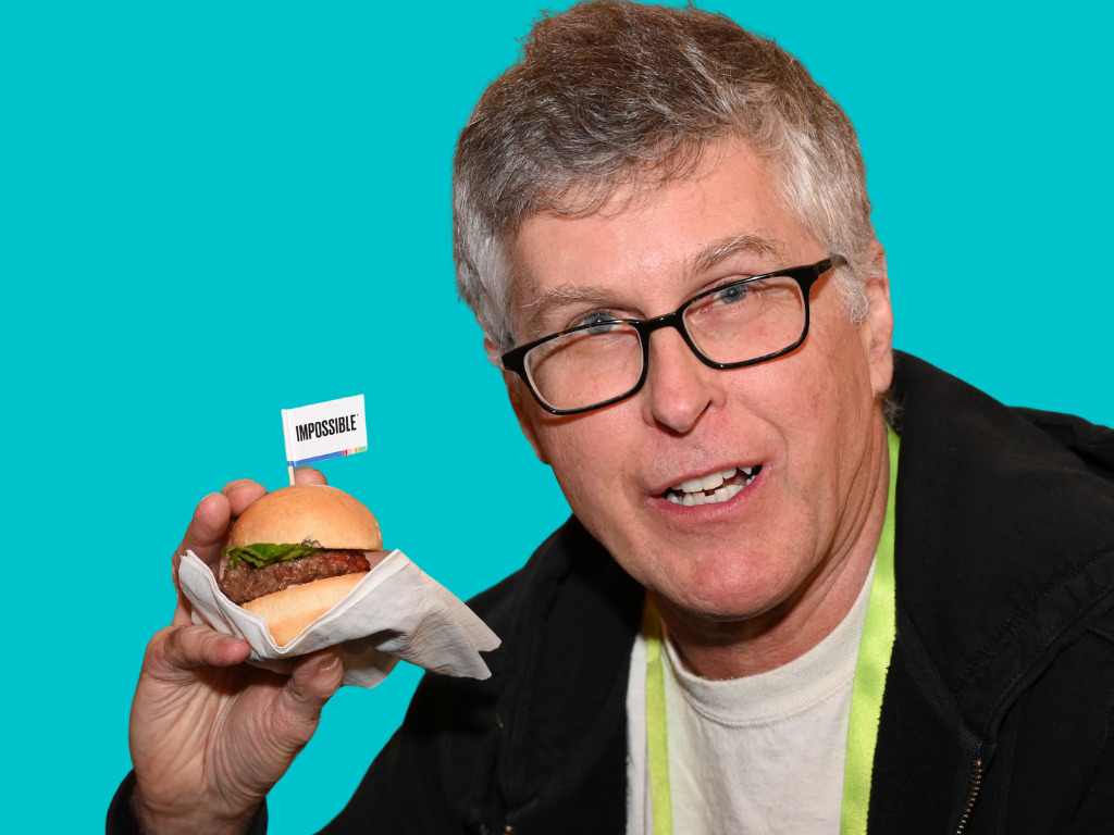 Impossible Foods founder Pat Brown with a burger